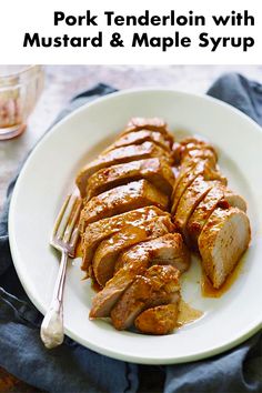 pork tenderion with mustard and maple syrup on a white plate