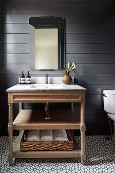 a bathroom with a sink, mirror and shelf in it's centerpieces