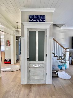 the entrance to a well - lit beach house