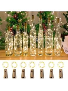 lighted wine bottles are sitting on a table next to christmas decorations and other holiday items