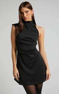 Get ready to turn heads at your next party night with the Rubie Mini Dress. This trendy one shoulder dress features a high neck and an asymmetrical hemline, giving it a unique and fashion-forward look. Made from ponte fabric, this A line dress hugs your curves in all the right places while providing comfort throughout the night. The black color adds a touch of sophistication, making it perfect for any occasion. Made from polyester, this mini dress is not only stylish but also easy to care for. P Short Black Dress Elegant, High Neck Mini Dress Formal, Cute Cocktail Dresses Classy, Black Dress Outfit Party Night Classy Winter, Black Dress Colorful Accessories, High Neck Cocktail Dress, High Neck Dress Jewelry, Classy Christmas Dress, Rehearsal Dinner Dress For Guest Winter