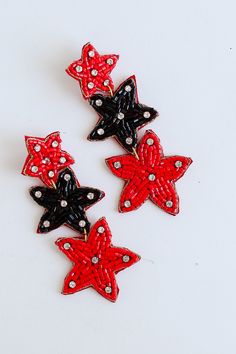 Heading to Athens soon for a game? The Red + Black Beaded Star Drop Earrings would be the perfect accessory for all of your game day outfits! These adorable earrings have a tiered star design with a stud post back. These were made for all the Dawgs fans! Beaded Stars Stud Post Back One Size | Length 3” Red Star-shaped Beaded Jewelry, Red Star-shaped Jewelry For Parties, Red Star-shaped Party Jewelry, Red Star-shaped Earrings For Party, Black Star-shaped Earrings For Party, Red Star-shaped Party Earrings, Star-shaped Beaded Jewelry For Party, Red Star-shaped Earrings With Star Charm, Red Star Charm Earrings