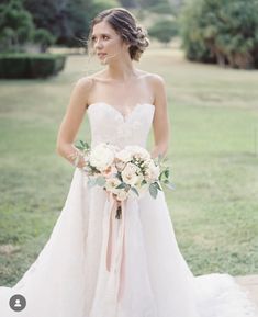 a woman in a wedding dress holding a bouquet