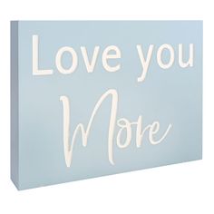 a light blue canvas with the words love you more written in white letters on it