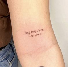 a woman with a tattoo on her arm that says, long story short i survived