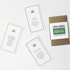 three little notes sitting next to each other on top of a white table with a brown envelope