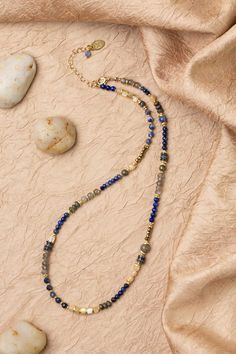 Discover the vibrant and stunning colors of the Blue Moon Collection in this eclectic necklace! Gold Filled (Lead & Nickel Free) Lapis Lazuli, Pyrite, Sodalite, Labradorite, Mother Of Pearl 16.5-18.5" adjustable length, with gold filled lobster claw clasp We hand select our natural materials, thus there may be slight variations in color and/or size that will not detract from the overall aesthetic. Our unique handcrafted designer jewelry for women is made in America, each design created individua Blue Labradorite Bohemian Jewelry, Bohemian Blue Labradorite Jewelry, Bohemian Blue Labradorite Necklace, Adjustable Blue Labradorite Necklace, Artisan Blue Labradorite Necklace, Multicolor Lapis Lazuli Beaded Necklaces With Natural Stones, Multicolor Lapis Lazuli Necklaces With Natural Stones, Multicolor Lapis Lazuli Beaded Necklace With Natural Stones, Multicolor Beaded Necklaces With Lapis Lazuli Stones