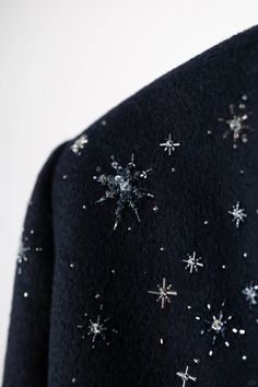 a black jacket with silver stars on it