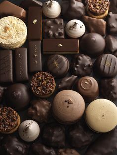 assorted chocolates and pastries arranged on a black surface