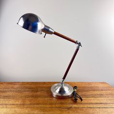 a desk lamp sitting on top of a wooden table