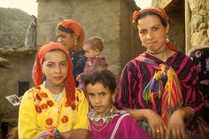 three women and two children in colorful clothing