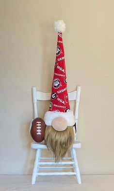 a football helmet sitting on top of a white rocking chair