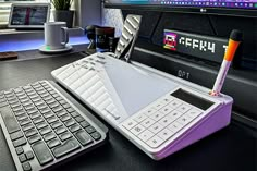 a keyboard and a calculator sitting on a desk in front of a computer monitor