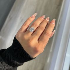 a woman's hand with french manies and a ring