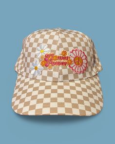 Upgrade your spring and summer style with our Flower Power Checked Cap. This white and tan checkered baseball cap features floral and heart patches for a playful yet stylish look. Get ready to rock your flower power vibes with this quirky and fun accessory! A Cactus Jane Original, made in house at our Laguna Beach store front Vintage Adjustable Baseball Cap For Spring, Cream Snapback Trucker Hat For Spring, Cute Spring Hat With Curved Bill, Retro White Trucker Hat For Spring, Cute Curved Bill Hat For Spring, Playful Cotton Baseball Cap For Spring, Vintage Baseball Cap For Spring, White Retro Trucker Hat For Spring, Fun Cotton Trucker Hat For Spring