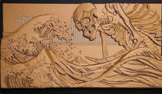 an intricate carved wood panel with a skeleton and waves