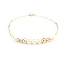 The perfect bracelet for everyday. This 14K gold filled bracelet is a contemporary update to the classic bead bracelet with a delicate row of gold filled beads and Swarovski cream pearls. Bracelet measures 6", 6.5", and 7" long. | The perfect bracelet for everyday. This 14K gold filled bracelet is a contemporary update to the classic bead bracelet with a delicate row of gold filled beads and Swarovski cream pearls. Bracelet measures 6", 6.5", and 7" long. | 1-800-Flowers Gifts Delivery 14K Gold Classic Gold Pearl Beaded Bracelets, Classic Gold Bracelet With Pearl Drop, Classic Gold Pearl Bracelet With Gold Beads, Classic Gold Pearl Drop Bracelet, Elegant Everyday Cream Jewelry, Classic Everyday Pearl Bracelet With 14k Gold Filled, Classic Gold Bracelets With Pearl Charm, Classic 14k Gold Filled Pearl Bracelet For Everyday, Gold Minimalist Pearl Bracelet With Gold Beads