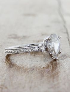 Charleen is a work of love and art. She oozes vintage flair that is hard to resist. Charleen holds a glorious pear shape center diamond that commands attention with her unique position. The diamond is nestled in between 0.18tcw of brilliant round white diamonds that act as her companion much like her future partner will forever and ever. Width of band is approximately 2mm. Drop-down diamond options represent our recommended grade, which maximizes size for value, while maintaining eye-perfect cla Future Partner, Pear Diamond Engagement Ring, Lab Diamond Engagement Ring, Curved Wedding Band, Rose Engagement Ring, Yellow Gold Setting, Rose Gold Engagement, Pear Diamond, Pear Shaped Diamond