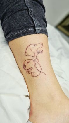 a woman's foot with a dog tattoo on her left ankle and right leg