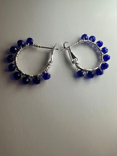 Sparkle and shine with these stunning blue glass crystal bead silver hoop earrings! Handcrafted to perfection, these earrings exude elegance and sophistication, making them the perfect accessory for any occasion. Elevate your style with the timeless beauty of blue glass crystals and silver hoops. Shop now in my Etsy store ✨ Adjustable Crystal Earrings With Faceted Beads, Blue Beaded Metal Hoop Earrings, Blue Small Hoop Jewelry With Dangling Beads, Blue Small Hoop Earrings Wire Wrapped, Blue Small Hoop Earrings With Wire Wrapping, Blue Wire Wrapped Hoop Earrings, Blue Small Hoop Earrings With Dangling Beads, Blue Wire Wrapped Round Hoop Earrings, Blue Small Hoop Wire Wrapped Earrings