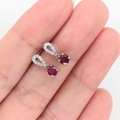 These beautiful drop earrings feature a pair of round red rubies with a natural earth-mined diamond studded bail, all set in solid 14K white gold. These earrings can be a lovely July birthstone gift for your loved ones! These studs are made with solid 14k gold and natural earth-mined SI G/H diamonds. As listed, these studs are ready to ship. If you're interested in purchasing this setting with a different center stone please message us! Ruby Earrings With Brilliant Cut In Fine Jewelry Style, Fine Jewelry Ruby Earrings With Brilliant Cut, Ruby Earrings Brilliant Cut Fine Jewelry, Ruby Brilliant Cut Fine Jewelry Earrings, Brilliant Cut Ruby Round Earrings, Red Diamond Drop Earrings, Ruby Gemstone Diamond Earrings In Fine Jewelry Style, Fine Jewelry Ruby Diamond Earrings, Ruby Gemstone Diamond Earrings For Formal Occasions