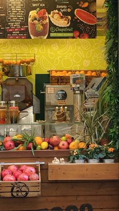 an assortment of fruits and vegetables on display in a store front with menus behind it