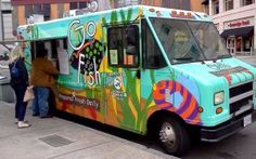 a colorful food truck parked on the side of the road