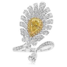 A one-of-a-kind Cocktail ring with a feather-like appearance dazzling with mesmerizing Yellow diamonds and white diamonds - Centre Diamond, GIA Certified Pear-shape Yellow Diamond 0.50 carat - Round Brilliant Cut Yellow Diamonds total 0.09 carat - Pear-shape White Diamonds total 0.50 carats - Round Brilliant Cut White Diamonds total 0.77 carat - Made of 18K White and Yellow Gold - Ring Size US6 (can be sized upon request) Yellow diamond primarily originates from South Africa. Approximately 1 out 16,500 carats that are mined are yellow diamond which also makes them rare. HYT Jewelry is a privately owned company headquartered in Hong Kong, with branches in Tokyo, New York, and Bangkok. The company specializes in fine jewelry. It is renowned for an exceptional range of Fancy Color Diamonds an Dig Jewelry, Yellow Diamonds, Colombian Emeralds, Timeless Jewelry, Fancy Color Diamonds, Yellow Diamond, Exquisite Jewelry, High Jewelry, White Diamonds