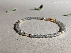 "This unique design features a string of gorgeous flashy labradorite and moonstone which glimmer in the light. These glamorous stones have an understated elegance and can go with any outfit, their simple design means this bracelet is guaranteed to be a long-time favourite. 💜 G E M S T O N E S 💜 * Gemstone: Natural Labradorite and moonstone. * Size: 2.5mm (tiny). * Cut: Micro-faceted round. * Origin: China * Birthstone Month: March. * Meaning: Labradorite is the stone of transformation, imparti Spiritual Labradorite Jewelry With Gemstone Beads, Labradorite Jewelry With Faceted Beads For Gift, Labradorite Jewelry With Faceted Beads As A Gift, Faceted Labradorite Round Beads Jewelry, Labradorite Gemstone Jewelry With Round Beads, March Meaning, Labradorite Necklace, Labradorite Beads, Minimalist Bracelet