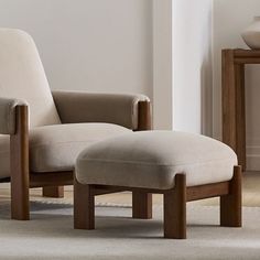 a chair and foot stool in a room