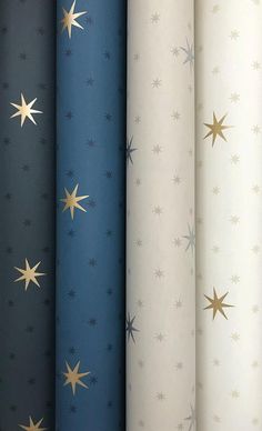 four different colored stars are lined up in the same pattern, each with gold and blue