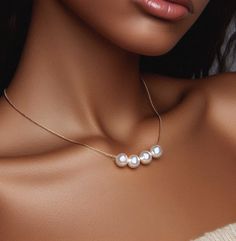 Our handmade pearl necklace, the epitome of timeless elegance and sophistication, perfect as a gift for a woman celebrating a birthday or as a cherished token for a bridesmaid. This exquisite necklace features lustrous pearls delicately strung together, creating a mesmerizing floating effect that exudes grace and beauty. Each pearl, a symbol of purity and wisdom, is meticulously selected for its flawless radiance, adding a touch of luxury to any ensemble. Whether she wears it with a casual outfi Elegant Silver Necklace For Birthday, Graceful Pearl Necklace As Gift, Graceful Pearl Chain Necklace As A Gift, Elegant Jewelry For Birthday, Elegant Round Jewelry For Birthday, Elegant Round Jewelry For Birthdays, Graceful Pearl Necklace For Gift, Graceful Pearl White Pearl Necklace As Gift, Pearl Jewelry For Birthday And Mother's Day