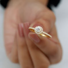 a person holding a diamond ring in their hand