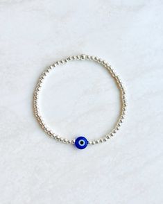 925 . E V I L . E Y E . B R A C E L E T   A beautiful handmade evil eye bracelet made with dainty sterling silver beads and a glass eye, on elastic.  Please note the evil beads are handmade therefore may differ slightly.  H O W . T O . O R D E R Select your size from the drop down menu.  O T H E R . I N F O R M A T I O N  Each bracelet comes in a high quality velvet gift pouch so it is the perfect item to gift to a loved one.  A B O U T ∙ B U M B L E BEADS   &  O U R . P O L I C I E S https://et Spiritual Sterling Silver Beaded Bracelets With Round Beads, Adjustable Sterling Silver Stretch Bracelet Gift, Adjustable Sterling Silver Beaded Bracelets With 8mm Beads, Round Beaded Bracelets With Silver Beads As Gift, Blue Sterling Silver Beaded Bracelets As Gift, Silver Bracelet With 8mm Beads As Gift, Sterling Silver Bracelets With 8mm Beads For Gift, Spiritual Sterling Silver Bracelets With Silver Beads, Handmade Blue Sterling Silver Beaded Bracelets