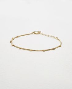 Slim and elegant bracelets never fail to impress us and we know every woman finds tons of uses for these in her collection. Meet all your dainty elegance goals with our Emery bracelet. The delicate design exudes tons of charm and femininity and will fit effortlessly into your hectic weekday dress-ups too.- Brass with Polyurethane Coating- Adjustable length of 7" to 9"- Available in Gold and Silver Adjustable Gold Bracelet With Satellite Chain, Delicate Chain Bracelet With Extender, Dainty Metal Bangle Charm Bracelet, Delicate Adjustable Charm Bracelet, Delicate Gold Bracelet With Satellite Chain, Delicate Adjustable Jewelry With Bracelet Strap, Trendy Adjustable Charm Bracelet With Delicate Chain, Adjustable Delicate Chain Beaded Bracelets, Elegant Metal Anklet With Adjustable Chain