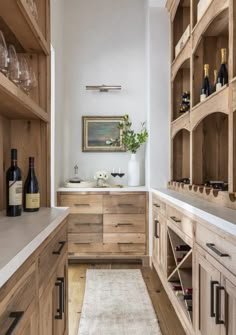 a kitchen with lots of wooden cabinets and wine glasses