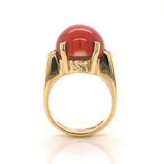 This beautiful Mid-Century cocktail ring features a cabochon cut red coral in 18 karat yellow gold. The coral has a medium scarlet red hue and is set in four golden prongs. The shoulders of the tapered band feature streamlined, openwork spaces for a bit of skin to peek through. From the profile, the Mid-Century details of the ring can truly be admired. The ring has a strong architecture and distinct style, finished in high polish 18k yellow gold. Right Hand Ring, Right Hand Rings, Hand Ring, Metal Shop, Shop Engagement Rings, Red Coral, Cocktail Ring, Cocktail Rings, Right Hand