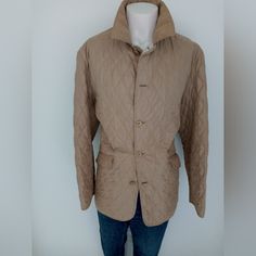 This Is A Beautiful Tan Quilted Jacket For The Stylish Man Who Wants Comfort And A Great Look To Complement Jeans And Boots. This Is A Size Large And Has Slanted Pockets Accompanied With A Button Vent Closure In The Back. I Will Take Offers That Are Reasonable As This Is A New And Never Worn Jacket. Also All Of My Items Are From A Smoke And Pet Free Environment. Measurements Are Upon Request. Classic Quilted Outerwear For Work, Winter Long Sleeve Quilted Blazer, Winter Quilted Long Sleeve Blazer, Classic Quilted Jacket For Winter Workwear, Classic Winter Quilted Jacket For Workwear, Classic Brown Utility Jacket For Spring, Classic Quilted Outerwear For Cold Weather, Classic Quilted Sport Coat For Fall, Fitted Beige Utility Jacket For Winter