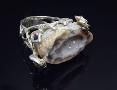 Raw Agate Tree Branch Silver Ring, Handcrafted Nature Ring With Geode Agate Discover the raw beauty of nature with this handcrafted silver signet ring. Each piece features a unique raw geode agate, embraced by a detailed branch design, representing the earth's untouched splendor. The ring's rugged texture and organic form make it a striking statement piece. Perfect for those who wear their connection to the earth on their sleeve. Embrace your love for the natural world with this one-of-a-kind ri Unique Agate Geodes, Silver Agate Geodes, Unique Open Ring With Raw Stone, Unique Raw Jewelry For Gifts, Handmade Agate Rings In Nature-inspired Style, Unique Crystal Ring With Large Stone, Agate Jewelry With Natural Stones In Open Ring Shape, Handmade Agate Rings With Nature-inspired Style, Silver Agate Geode With Natural Stones