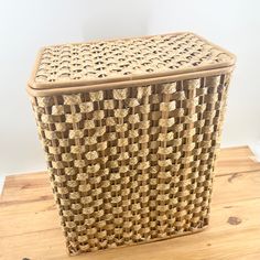 a woven basket sitting on top of a wooden table