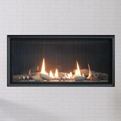 a white brick wall with a fire burning in it