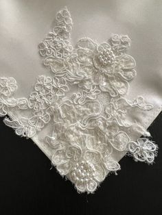 an embroidered white cloth with flowers on it