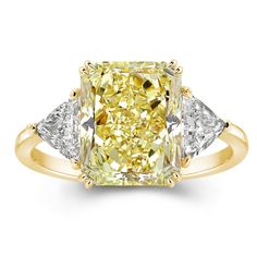 a fancy yellow diamond ring with three diamonds