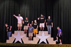 a group of people standing on top of a stage