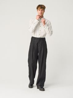 "Exquisite linen trousers for men -- flowy, pleated, and packed with details that ensure impeccable fit. Offered in heavy-weight linen. If you're interested in a medium-weight option, you'll find another THEO listing in our MEN'S section. STYLE DETAILS  * Relaxed fit * Wide, straight leg * High waist with elasticated back  * 2 front pleats * Fastens with 2 buttons and a zipper * Side pockets * Full length * Made from heavy-weight linen SIZES & COLORS IN PICTURES * Model wears size L in color Black Heavy and size M in color Magnetic Blue. He is 188 cm (6'2\"). Chest - 97 cm (38\"), waist - 83 cm (33\"), hips - 97 cm (38\"). NOTES ON SIZING & COLORS * Please note that linen shrinkage during the softening process cannot be predicted precisely. Therefore, each piece in the same size can vary 1 Mens Flowy Fashion, Male Linen Pants, Wide Trousers Outfit Men, Wide Pleated Pants Outfit Men, Wide Leg Trousers Outfit Men, High Waisted Trousers Men, Mens Wide Pants, Wide Fit Pants Men, Linen Trousers Outfit Men