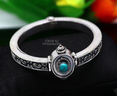 Handcrafted 925 sterling silver fabulous turquoise bangle bracelet kada. fabulous attractive design work silver jewelry with amazing locking system, excellent wedding or party jewelry/gifting jewelry from India. Metal-925 sterling silver. Type-Bangle/bracelet/kada. Width of bangle-0.8 centimeter. Size-2-6 or 2.375 inches or 6.0 cm inner diameter(2-6/2-7 comfort with both sizes) Weight-53.960 grams approx. for single bangle. Stamped-925. stone part width-3.2 centimeters. Finish-Oxidized. Stone-Tu Silver Openable Bracelets As A Gift, Silver Openable Bangle Jewelry, Silver Openable Bracelets For Gift, Silver Openable Bracelet For Gift, Openable Silver Bangle Jewelry, Openable Bracelet Jewelry Gift, Silver Gemstone Bracelets For Festivals, Single Bangle, Turquoise Bangle