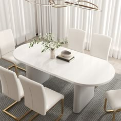 a white dining table with four chairs around it