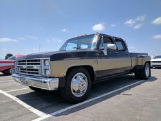 an older pickup truck parked in a parking lot