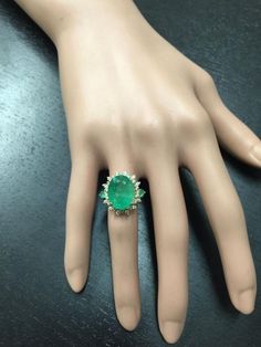 6.42 Carats Natural Emerald and Diamond 14K Solid Yellow Gold Ring Suggested Replacement Value: $7,900.00 Total Natural Green Emerald Weight is: 5.67 Carats Emerald Measures: 13.90 x 10.76mm Natural Round Diamonds Weight: .75 Carats (color G / Clarity SI1) Ring total weight: 5.8 grams Disclaimer: all weights, measurements and colors are approximate and may vary slightly from the listed dimensions or as seen in the image. All pictures are magnified to show the smallest of details. Please, refer t Elegant Green Gia Certified Gemstones, Dazzling Green Diamond Ring For Formal Occasions, Luxury Green Emerald Ring For Formal Occasions, Formal Green Diamond Ring, Elegant Green Gemstones For Formal Occasions, Formal Green Pear-shaped Diamond Ring, Formal Multi-stone Emerald Gemstones, Luxury Pear-shaped Emerald Ring For Formal Occasions, Luxury Green Diamond Ring For Formal Occasions