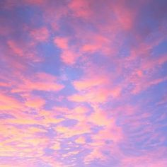 the sky is pink and blue with clouds